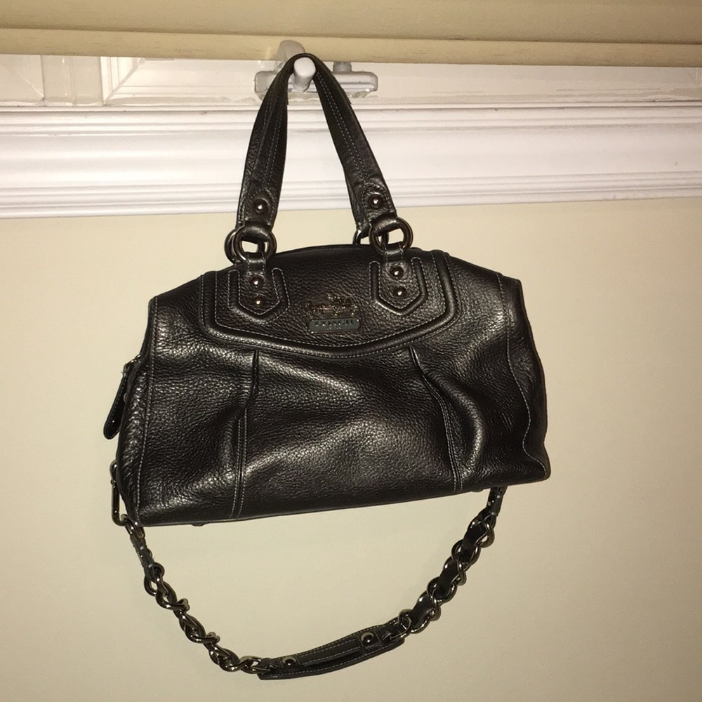 A Coach satchel with a shoulder strap.